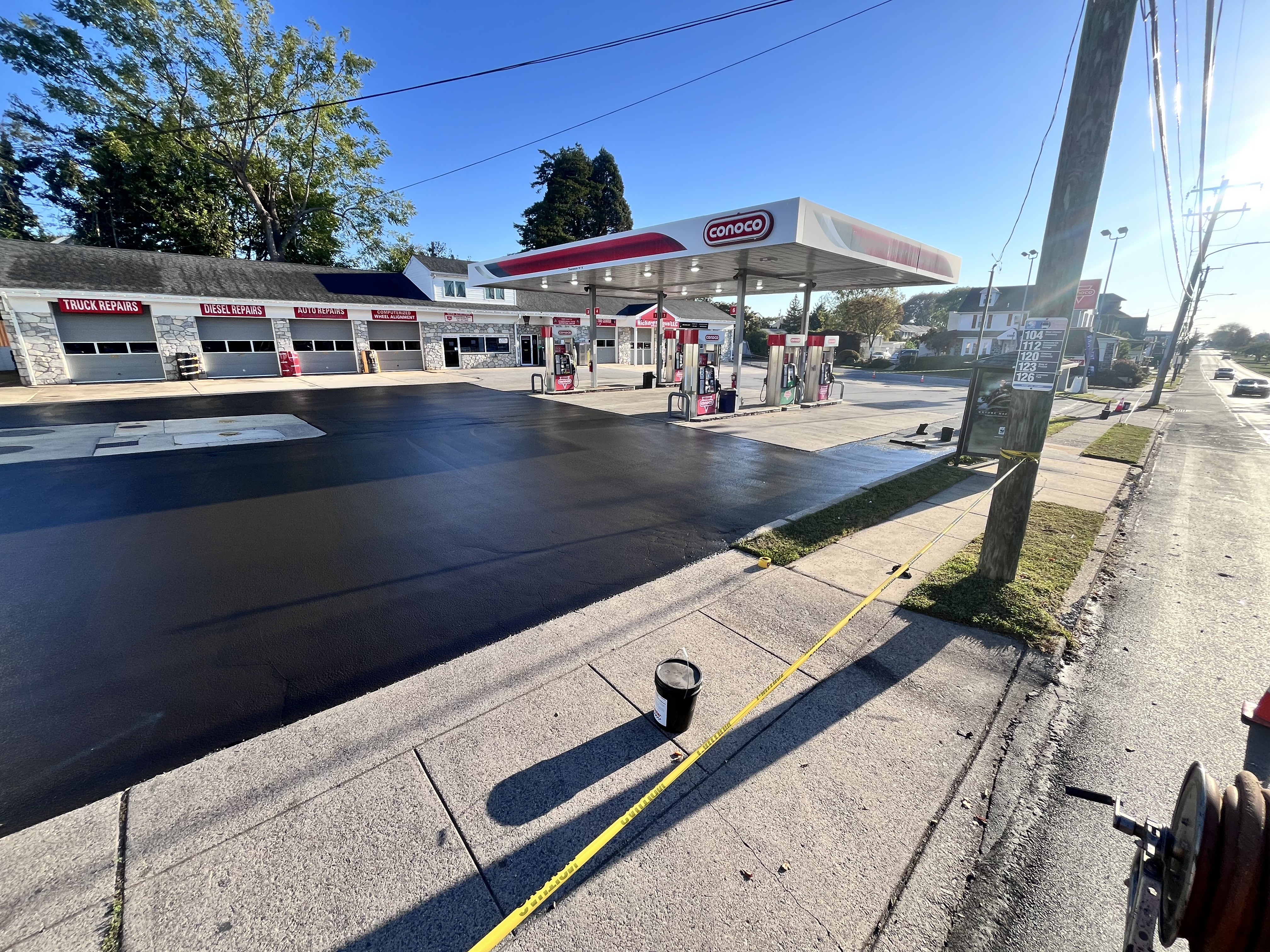 Commercial parking lot sealcoating — Conoco gas station, daytime
