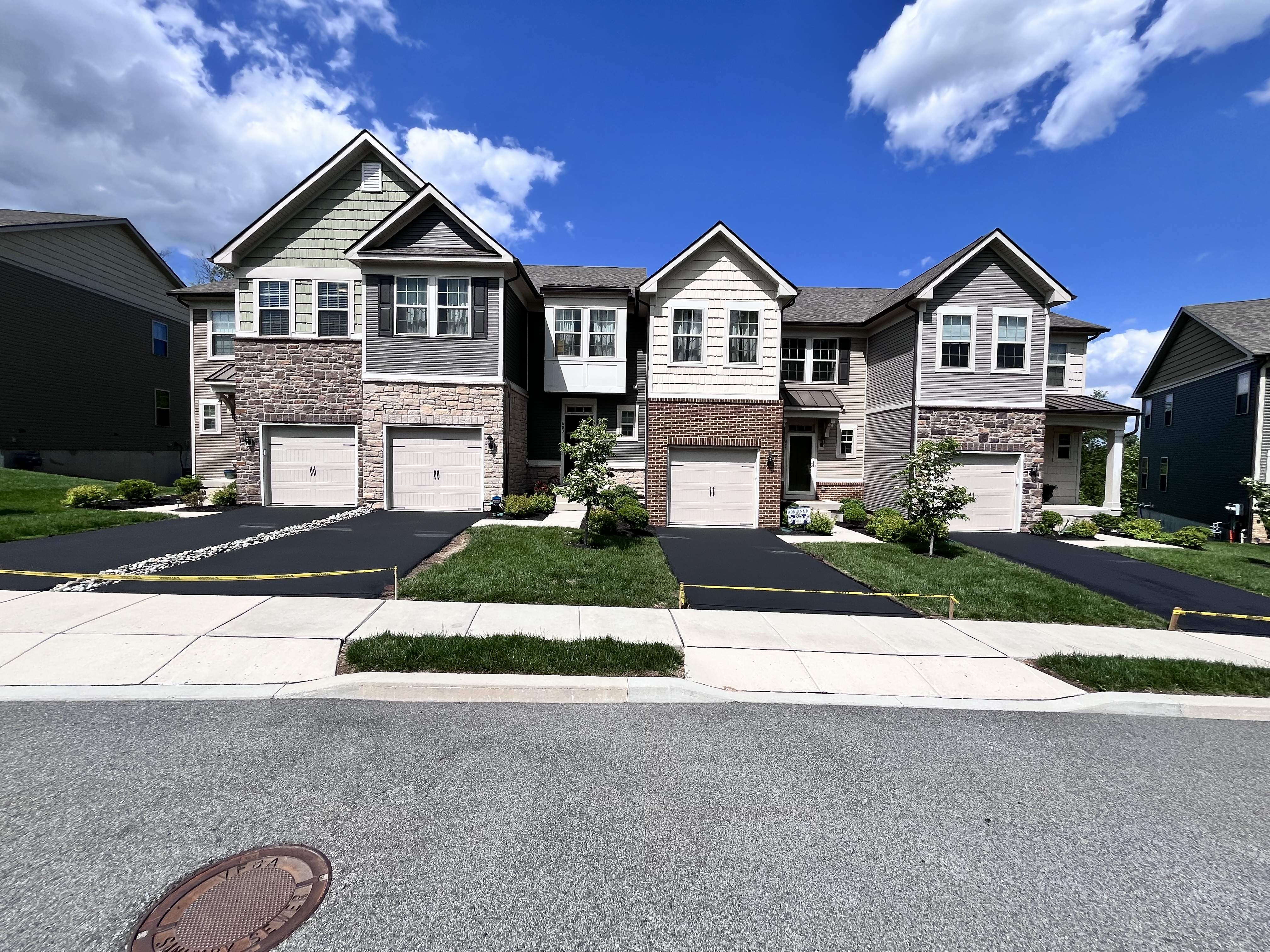 Townhome community driveways freshly sealed — HOA sealcoating project
