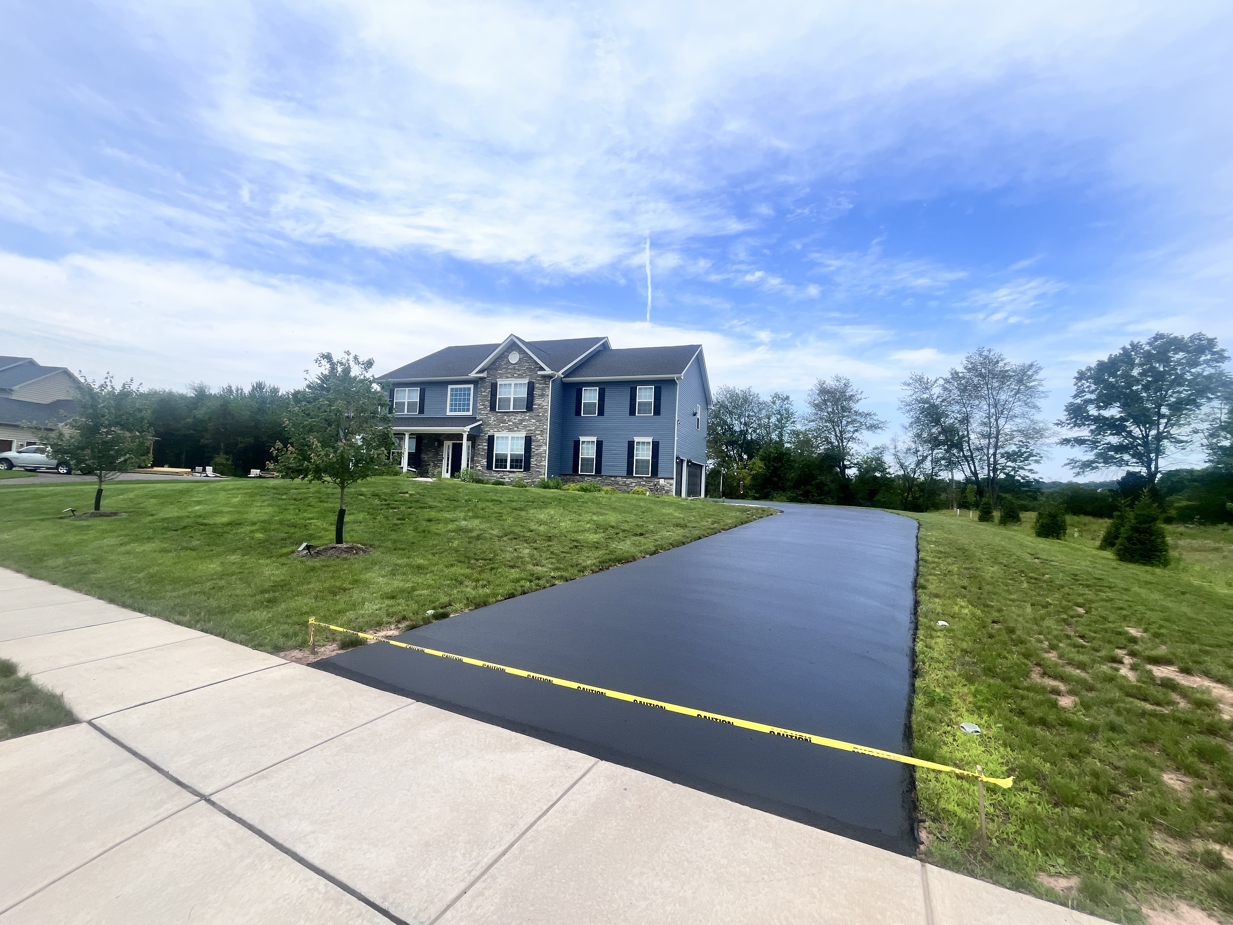 Wide freshly sealed driveway on large property — Montgomery County PA