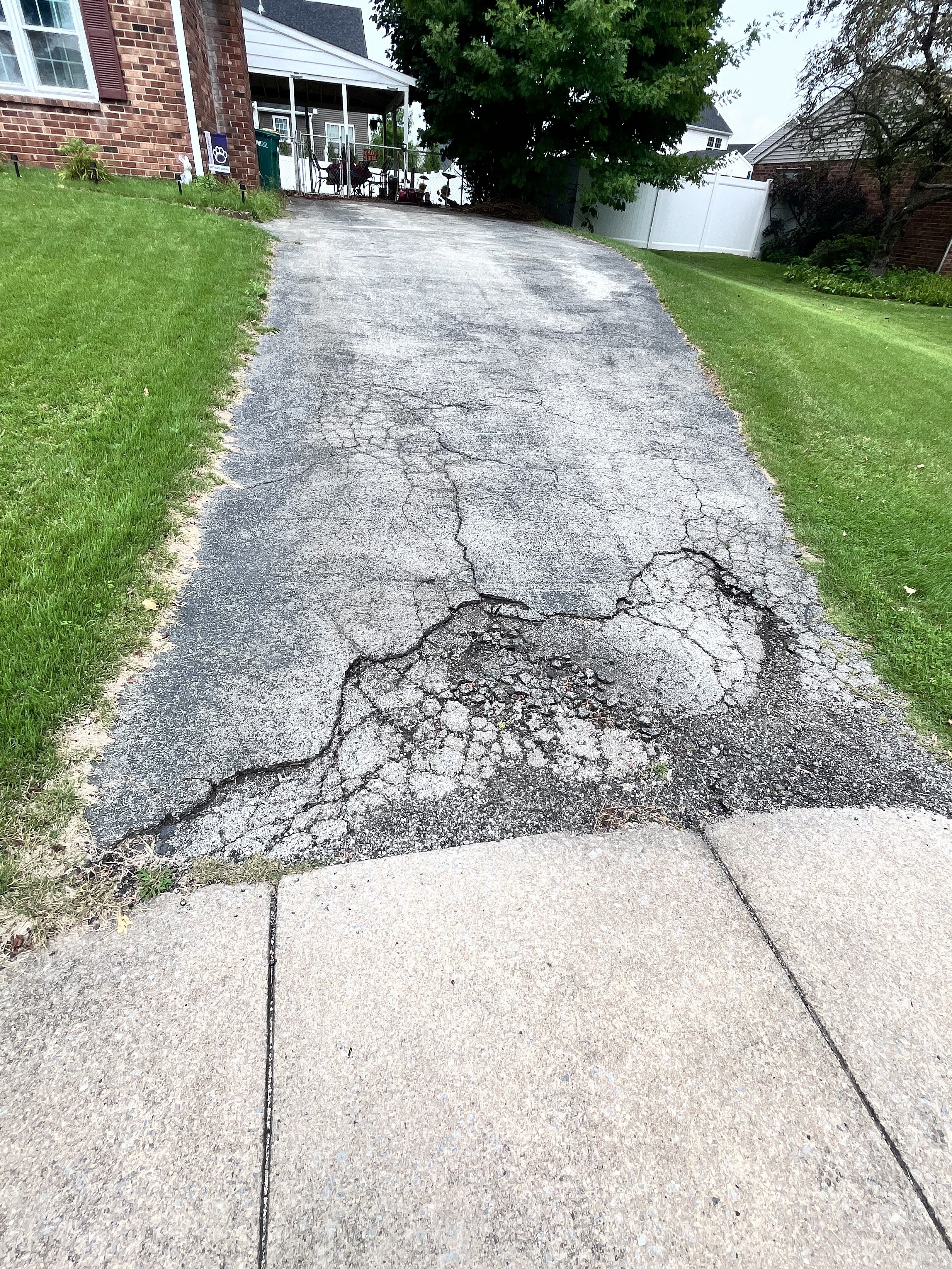 Driveway before repair — cracked and deteriorated