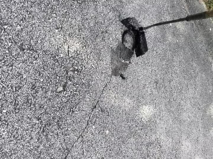 Crack sealing work on asphalt surface