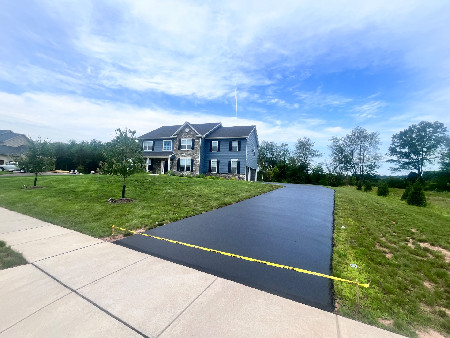 Freshly sealed residential driveway — Derek's Sealcoating
